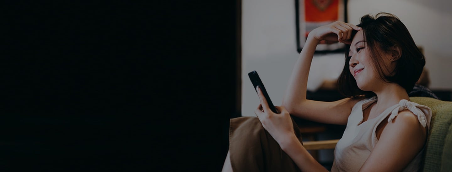 A happy Citi user looking at her increased credit limit on her mobile phone